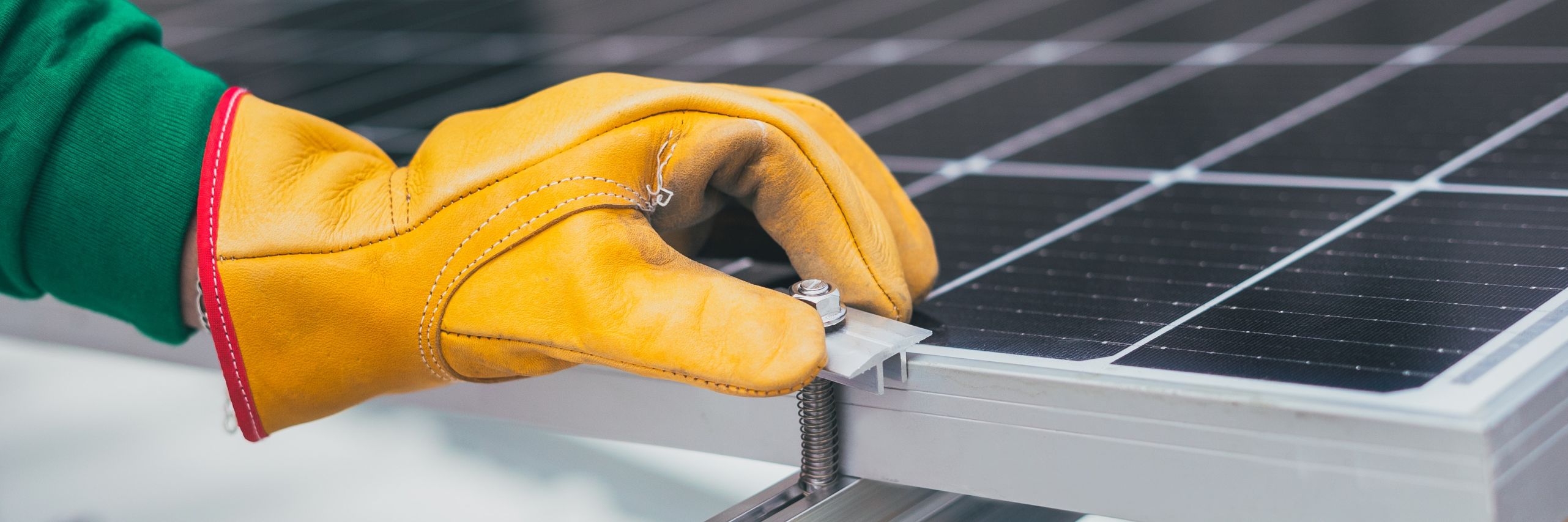 Gloved hand adjusting solar panel