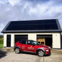 PureVolt vehicle parked outside an Irish home with solar panels on the roof